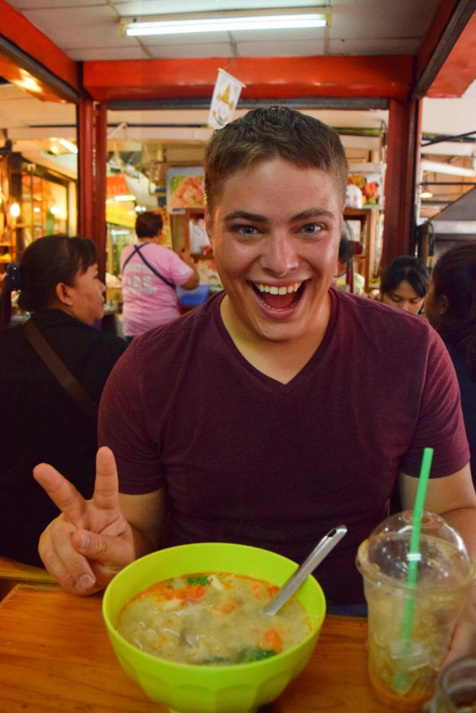 在泰国曼谷的chatuchak市场，Jeremy storm吃着一碗汤