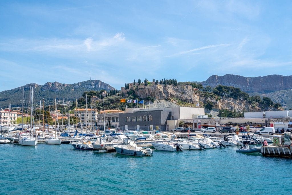 Port de Cassis, Provence, France, with boats tied up to docks and the Chateau de Cassis in the background