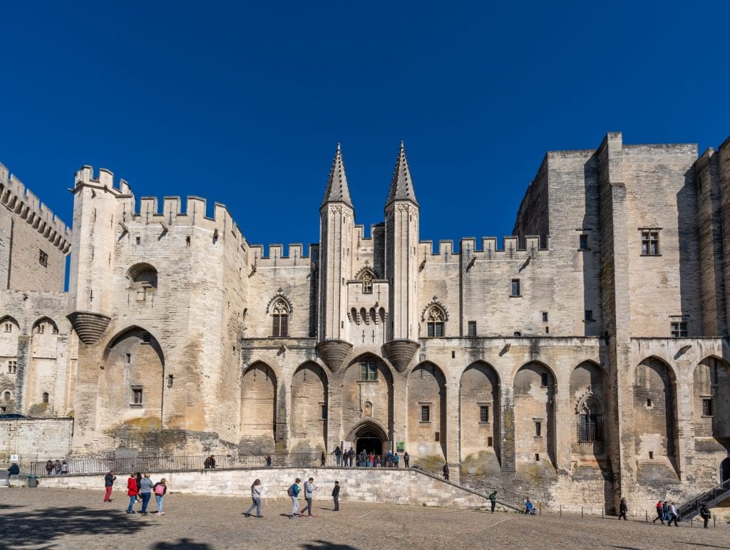Photo of the exterior of the Papal Palace in Avignon. Don't miss this stop on your south of France itinerary!