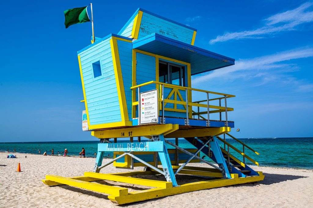Blue and yellor art deco lifeguard stand on South Beach in Miami, which is a must-see beach for your USA bucket list!