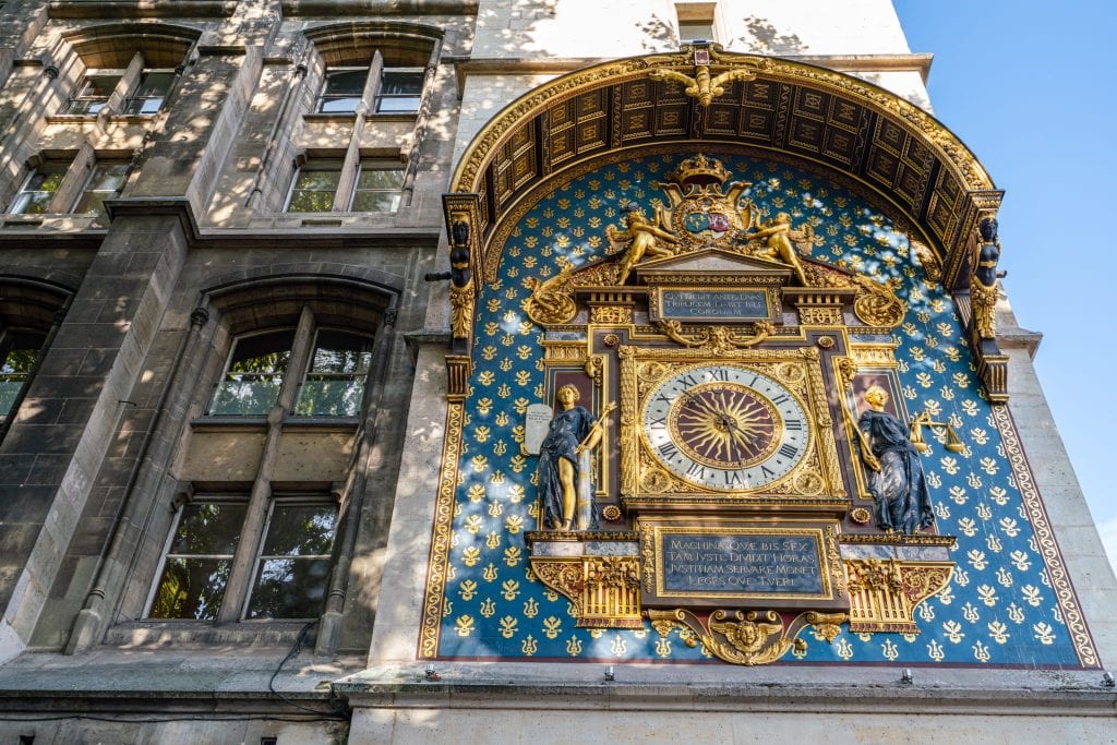 Oldest clock in Paris located on the side of the Conciergerie. The clock is blue and gold, and definitely worth slowing down to take a peek at during any Paris itinerary!