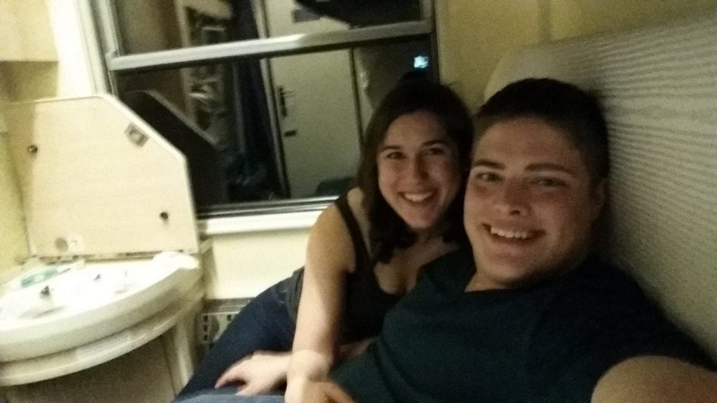 Kate Storm and Jeremy Storm selfie on a sleeper train through Europe