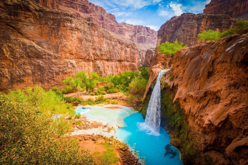 Havasu Falls in Arizona, one of the most beautiful places in USA. Turquoise waterfall with orange walls surrounding it