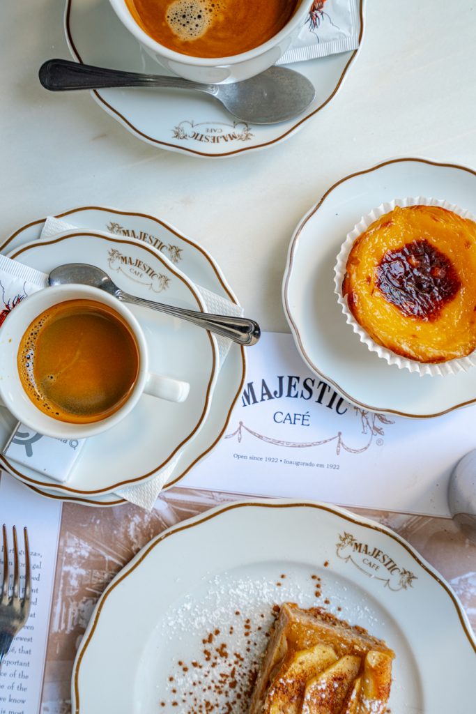 在葡萄牙波尔图的一天，蛋糕和咖啡铺在宏伟的咖啡馆的桌子上