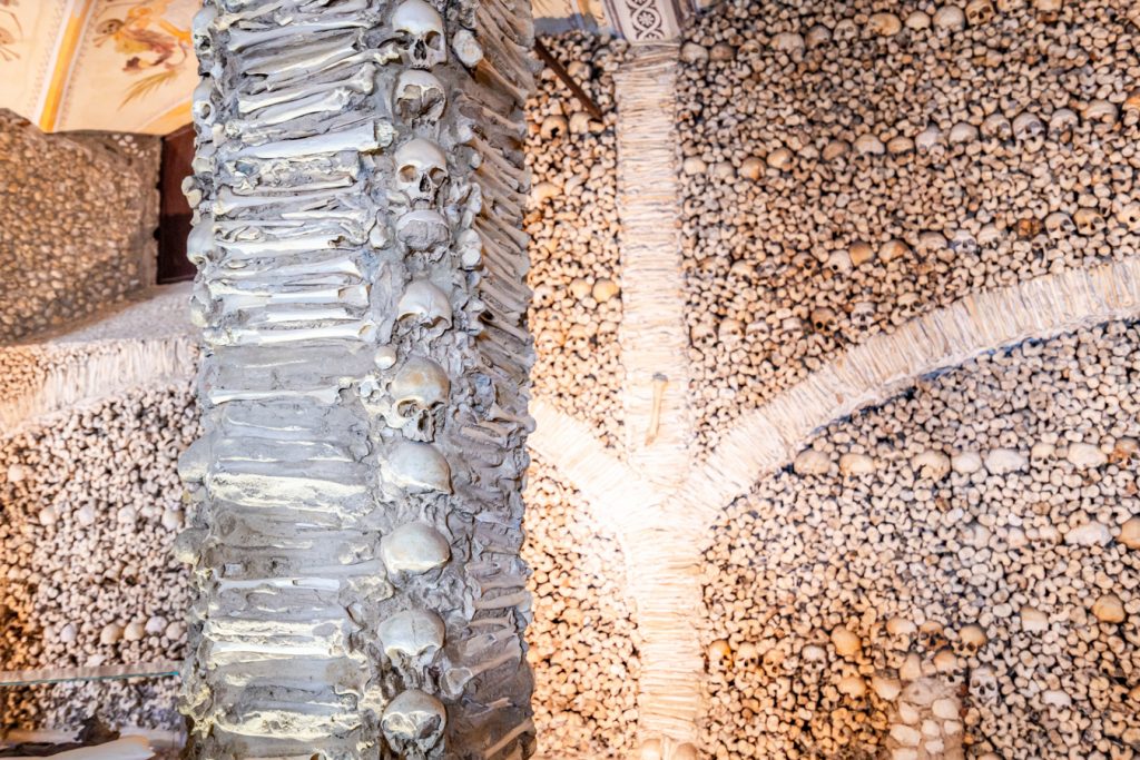close up of column of skulls inside bone chapel evora attractions